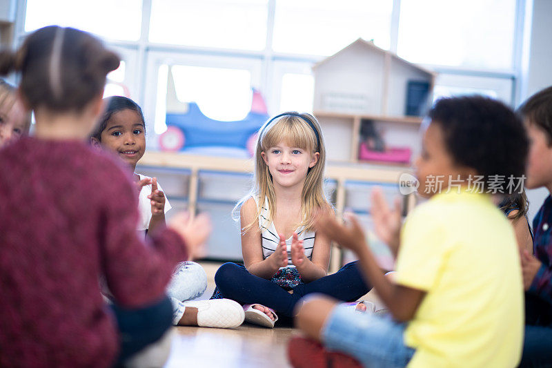 幼儿园班级唱歌和拍手在圆圈时间库存照片