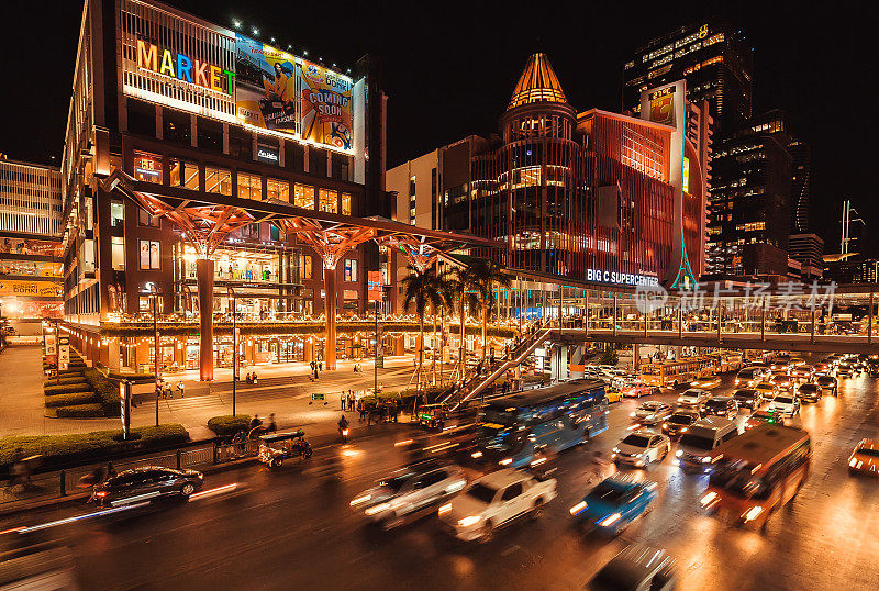 运动模糊从各种各样的交通在明亮的街道与灯光，购物中心，汽车在夜间的道路上
