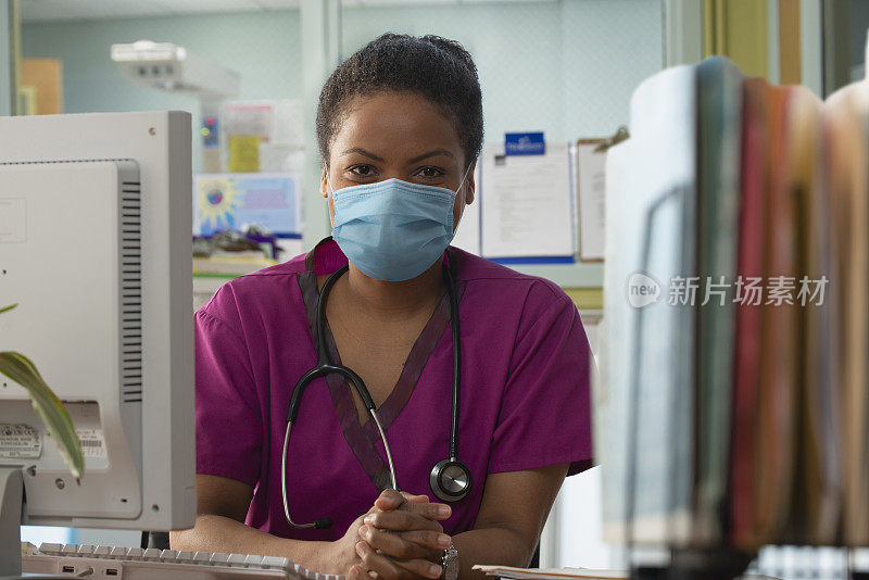 戴着防护口罩在医院工作的妇女