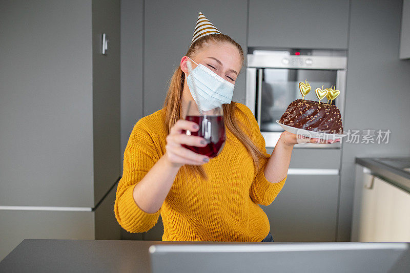 一个戴着面具的年轻女子在视频通话中庆祝生日