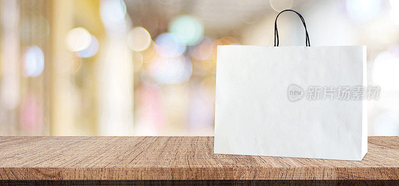 白色购物袋木制桌子上模糊的商店背景，业务，模板，产品展示蒙太奇背景，横幅