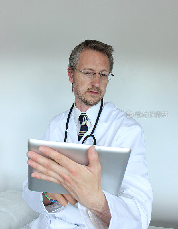 年轻的医院医生在电脑屏幕上检查结果