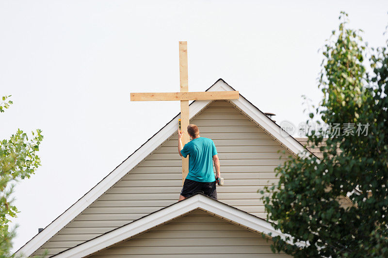 在屋顶上安装木十字架