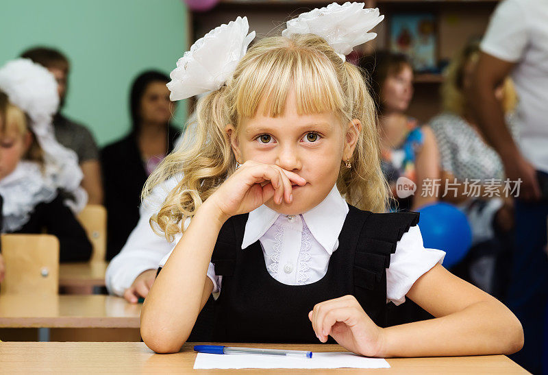 一年级女孩坐在课桌前上课