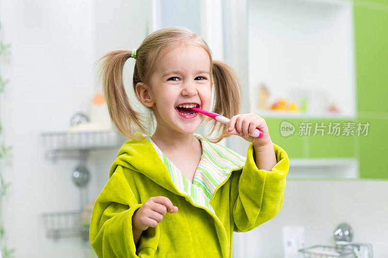 微笑的小女孩在浴室刷牙