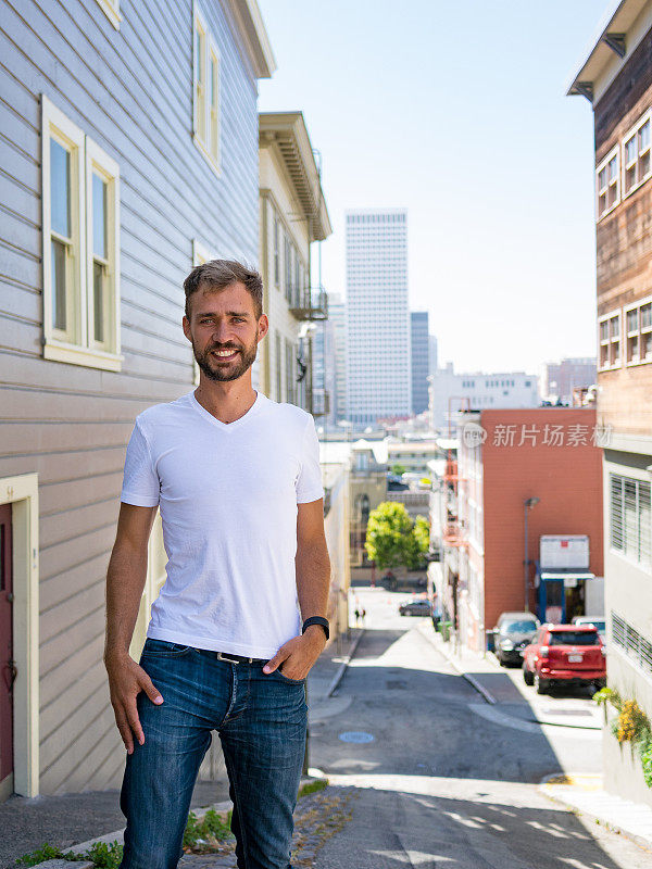 在美国加利福尼亚州旧金山市，年轻男子在蓝色牛仔裤白衬衫的城市场景的肖像