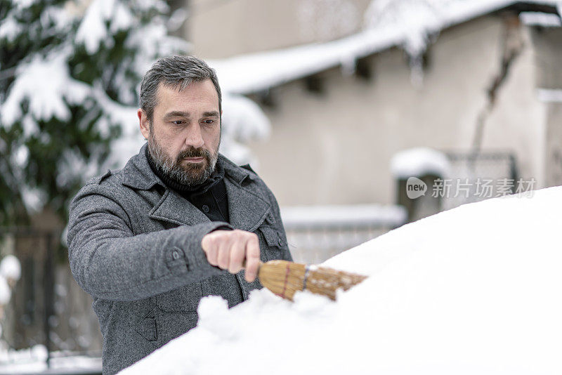 从车上清除雪的人