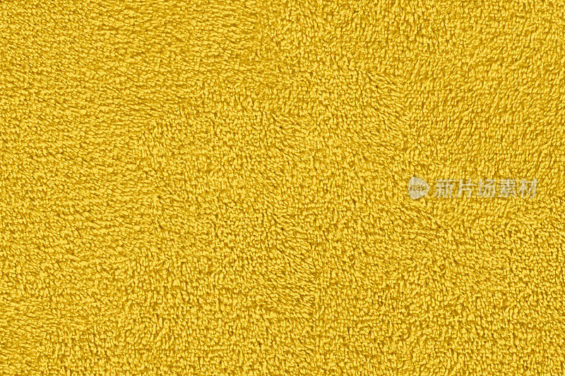 黄色天然棉布毛巾为背景，特写黄色毛巾纹理。