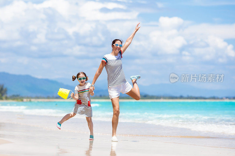 母亲和孩子在热带海滩上。海上度假