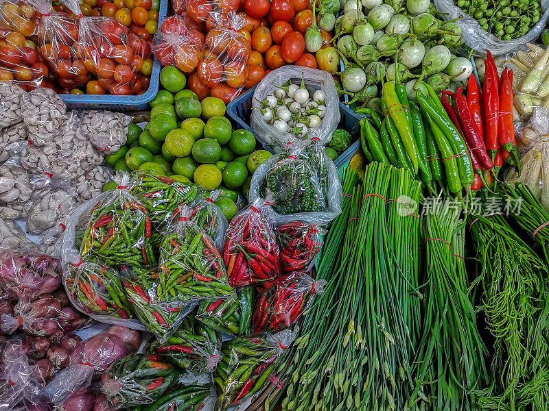 清迈的老沃拉沃市场上，摊贩的柜台上陈列着新鲜的泰国蔬菜。