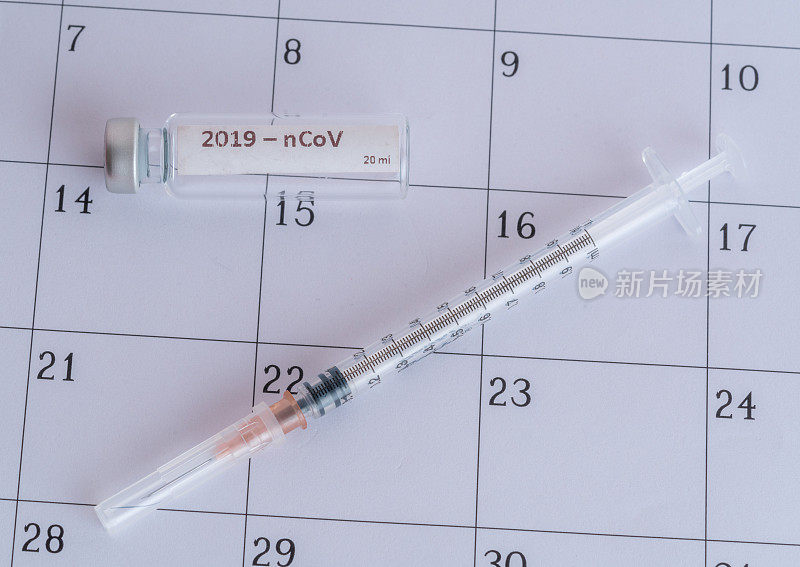 注射器和疫苗的日历库存照片