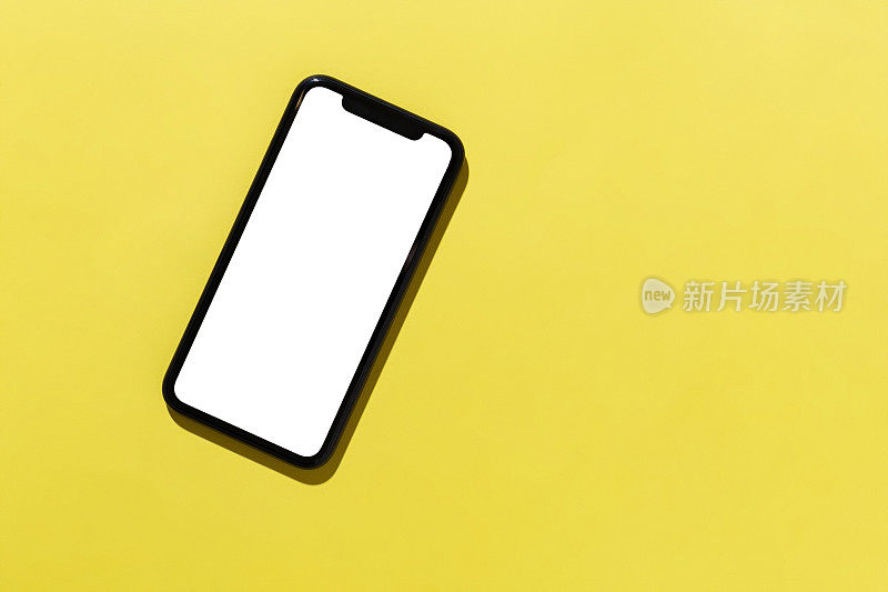 黄色背景上的现代智能手机模板，俯视图
