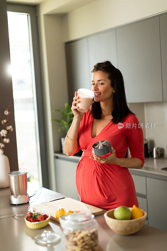 美丽的白人孕妇在厨房做饭