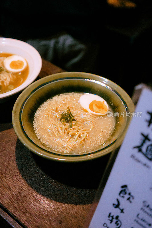 厨师用自制的酱料准备一碗拉面