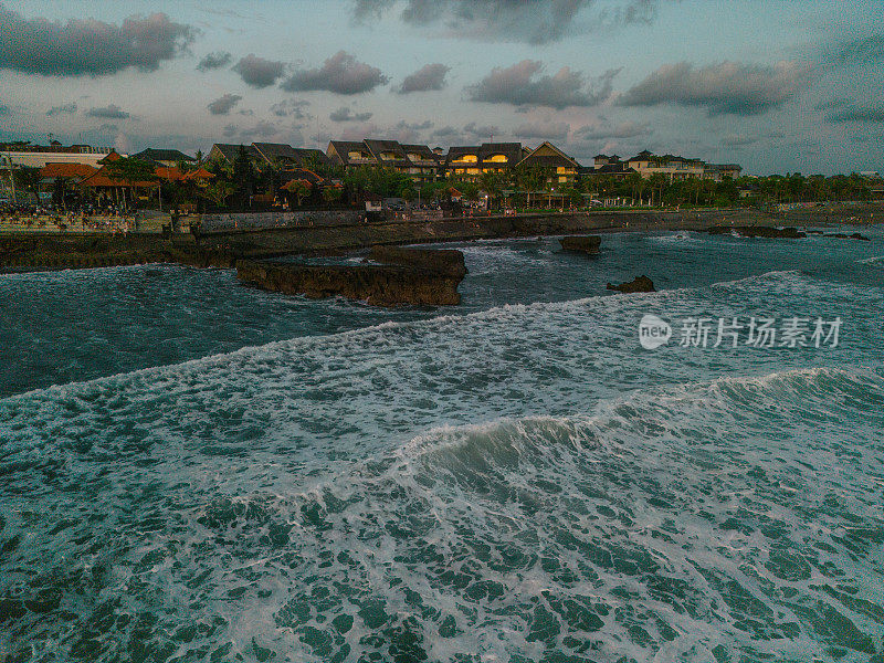 日落时巴厘岛海滩的鸟瞰图