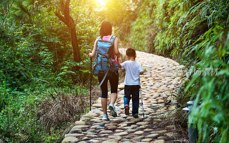 亚洲母亲和儿子在森林里徒步旅行