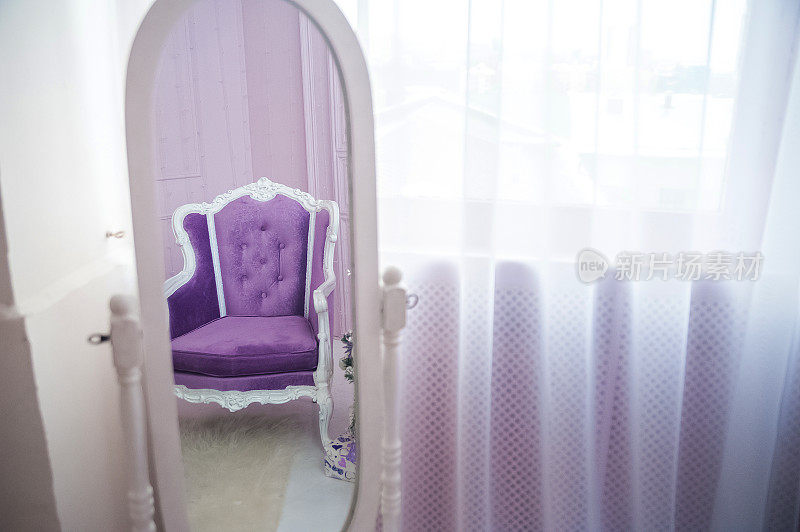新年室内配紫色沙发特写和拷贝空间。客厅里有沙发和霓虹色圣诞树。