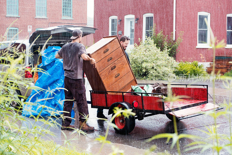 两个学生在一个下雨天搬家具