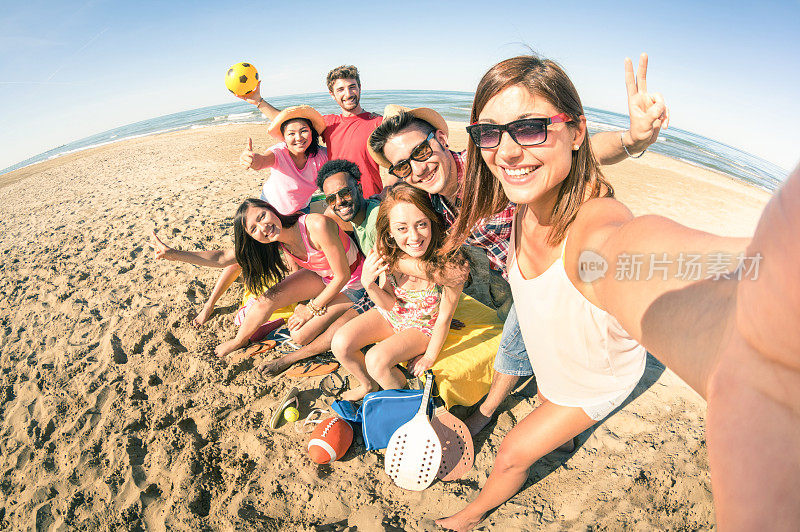 一群多种族的快乐的朋友在海滩自拍的乐趣