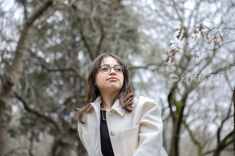 美丽的女人在秋天在公园里