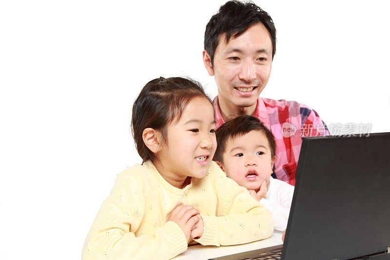 父亲和孩子们在玩笔记本电脑