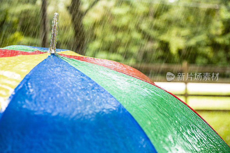 雨天。雨点落在户外五颜六色的伞上。春天,夏天。