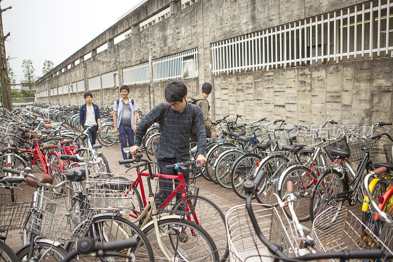 年轻的日本学生在日本京都停放自行车