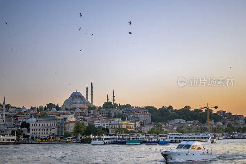 日落时分的耶尼卡米清真寺和苏莱曼尼清真寺，土耳其伊斯坦布尔