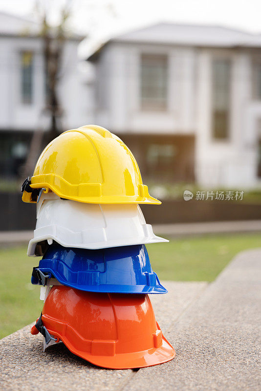建筑工人，工程师，技术人员，在建筑工地工作的检查员的头盔。工作时戴安全安全帽，防止事故发生。蓝领的工作设备