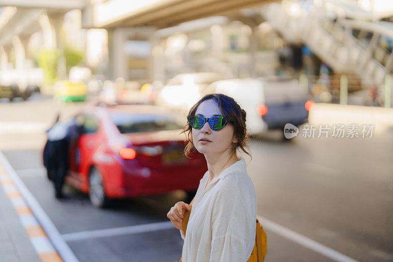 一名女子探索曼谷这座充满活力的城市。她正在等出租车