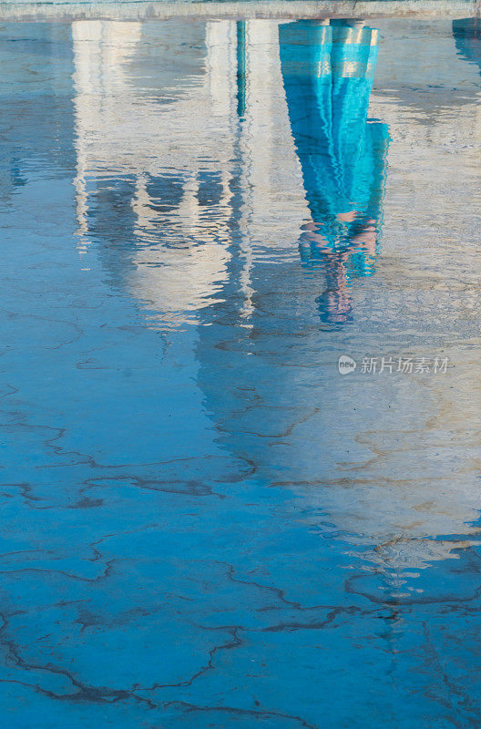 身着蓝色纱丽的年轻女子站在泰姬陵前