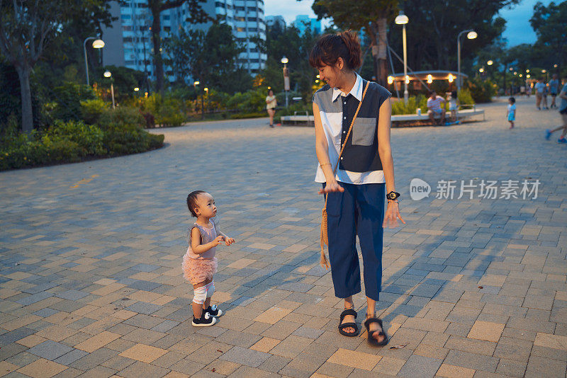 亚洲幼儿在母亲的鼓励下学习走路