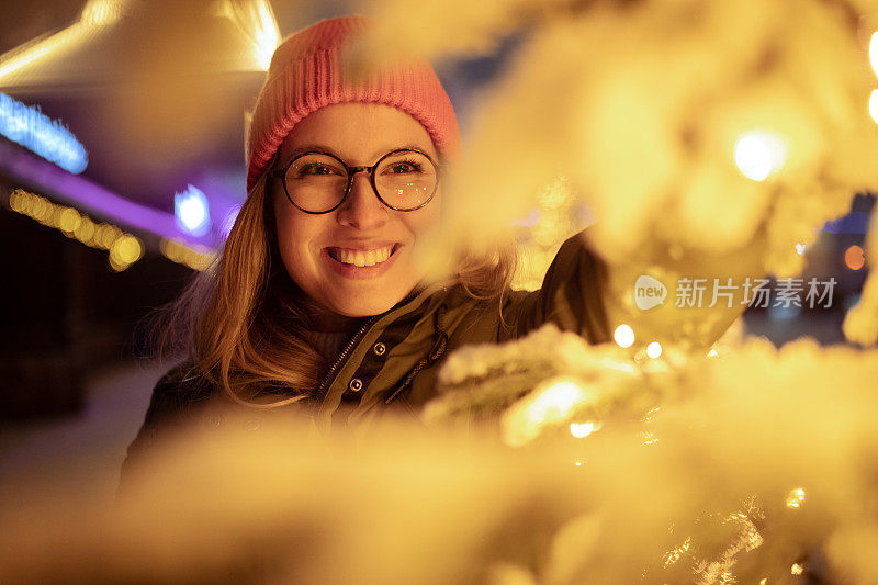 快乐的女人在户外享受圣诞装饰