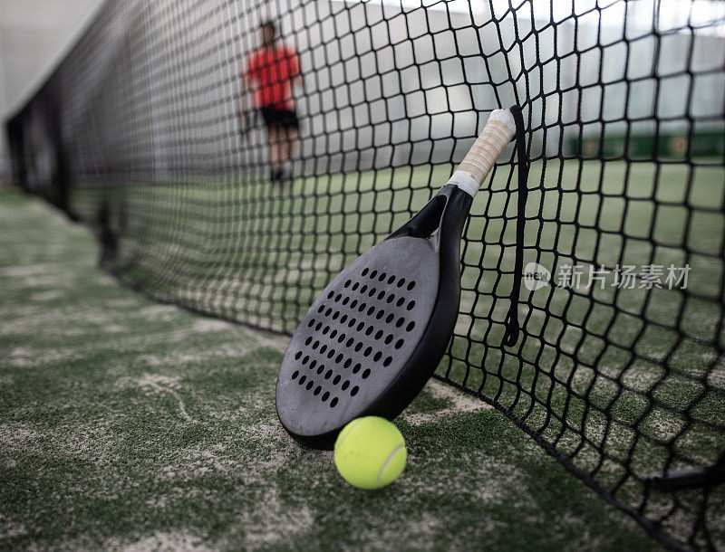球拍网球拍和球在球场上，模糊层的背景