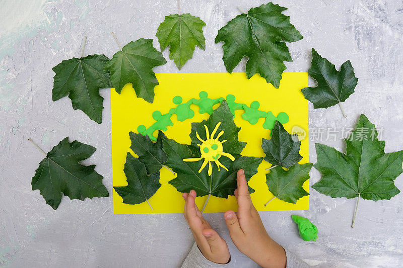 孩子在玩橡皮泥、纸和天然树叶。保护环境，拯救地球。生态学的概念。艺术学习与教育理念