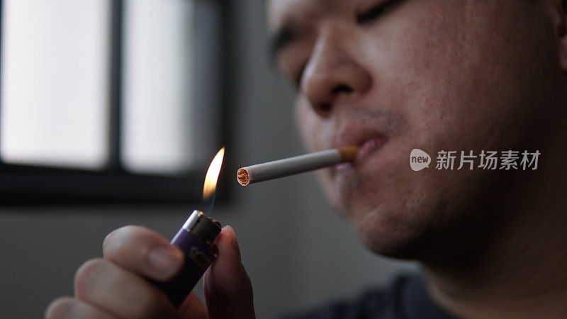 年轻亚洲男子吸烟