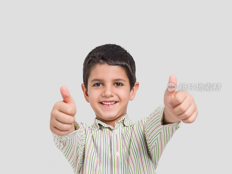 自信的孩子竖起大拇指的肖像