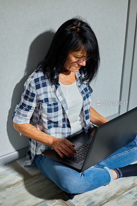 女高年级女生使用笔记本电脑键盘打字、工作、写电子邮件