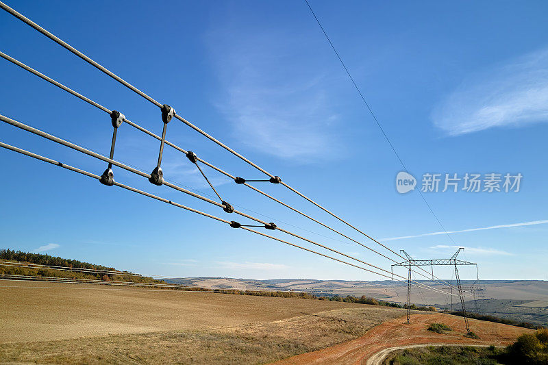 高压塔的电力线路由安全保护套管分隔，通过电缆将电能安全转移。长距离输电的概念