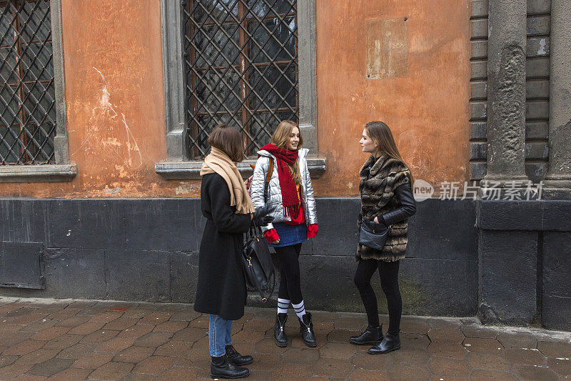 年轻的白人女孩模特朋友站在乌克兰利沃夫大街