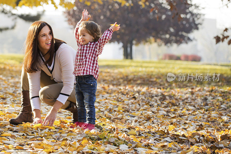 妈妈和女儿在玩树叶