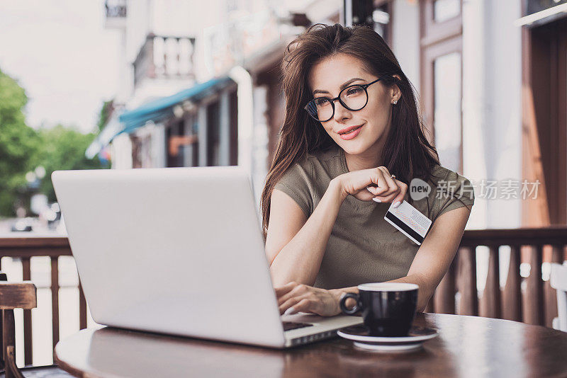女人正在用笔记本电脑和信用卡网上购物