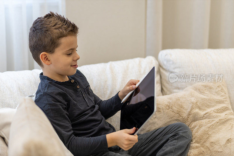 小男孩在玩他爸爸的iPad