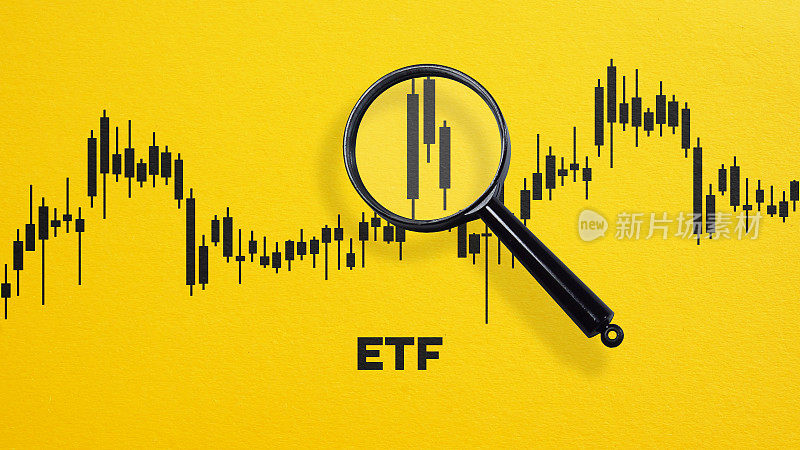 交易所交易基金首字母缩略词和图表通过放大镜在橙色背景