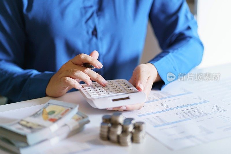 女商人用计算器计算财务报表，网上报税和纳税。