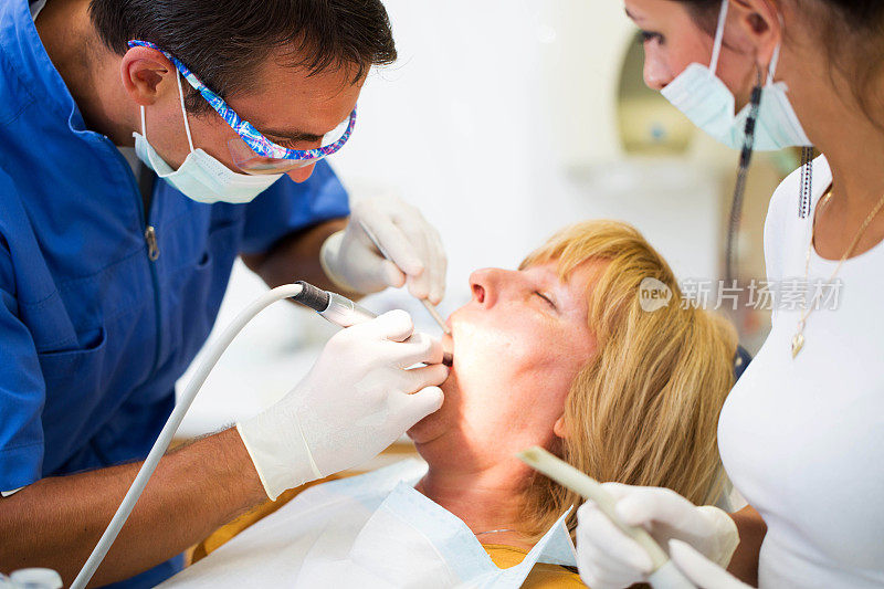 看牙医的中年妇女……医生和护士工作