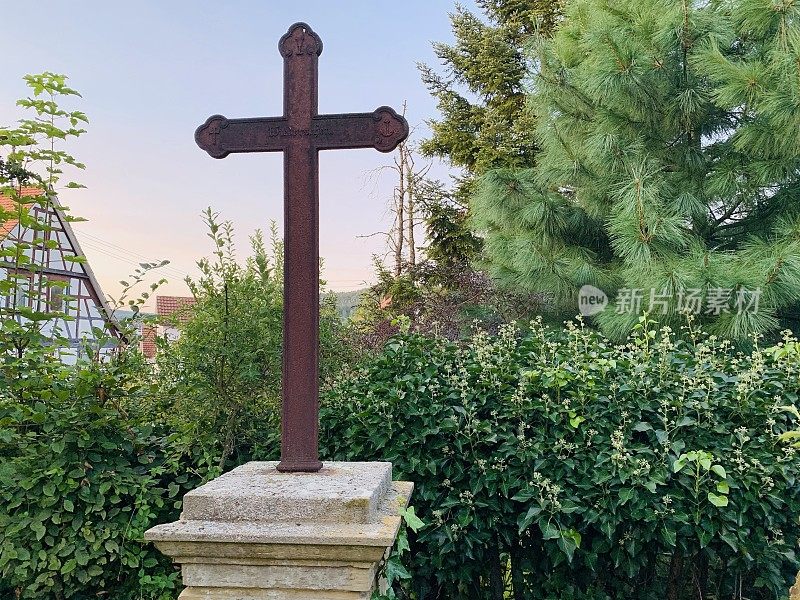 老风化生锈的十字架在墓碑上