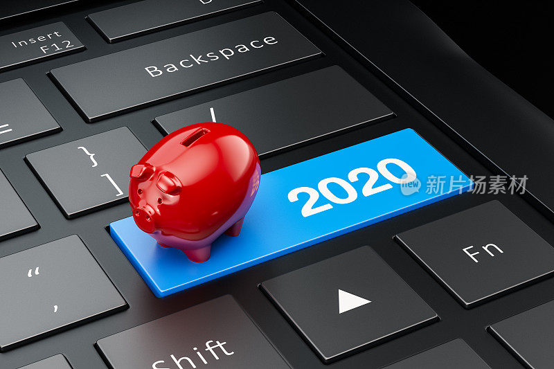 电脑键盘上的红色储蓄罐。2020年新年概念