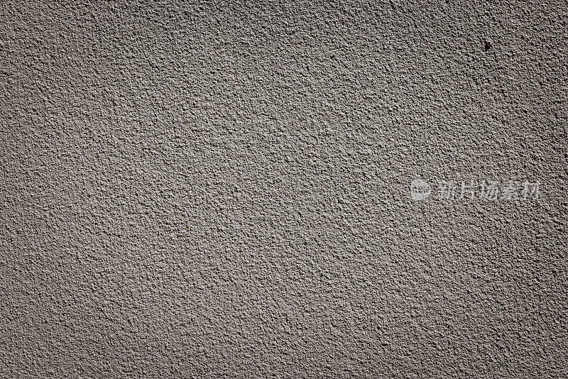 粗糙的米色混凝土墙的一部分