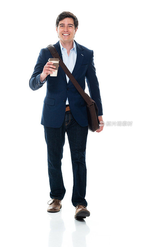 白种年轻男性商务人士肩挎包，手拿咖啡杯走在白色背景前